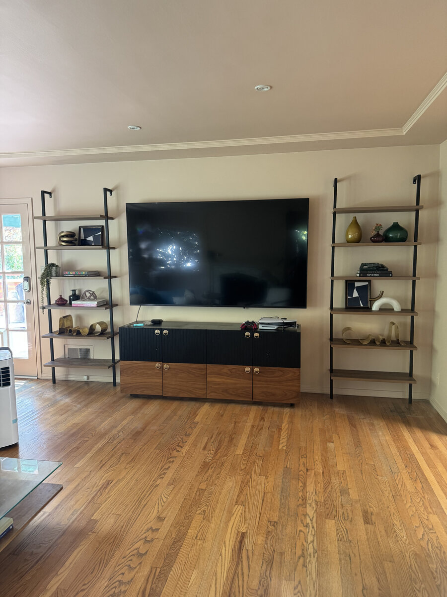 Wall-mounted TV with matching floating shelves and styled decor